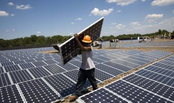 HILLSBOROUGH, NJ - JULY 15: Employees of SunEdison install photovoltaic solar panels on the roof of a Kohl's Department Store on July 15, 2008 in Hillsborough, New Jersey. Company engineers estimate Kohl's will be able to reduce their electricity usage on average by 25% once power begins flowing from the 1980 rooftop panels. Kohl's signed a contract with SunEdison, based in Beltsville, Maryland, to receive electricity for 20 years at a reduced price from public utility rates. New Jersey is the nation's second largest producer of solar energy behind California. State and federal tax incentives help individuals and commercial enterprises cover the costs of solar panel installations. SunEdison is North America's largest solar energy service provider. (Photo by Robert Nickelsberg/Getty Images)